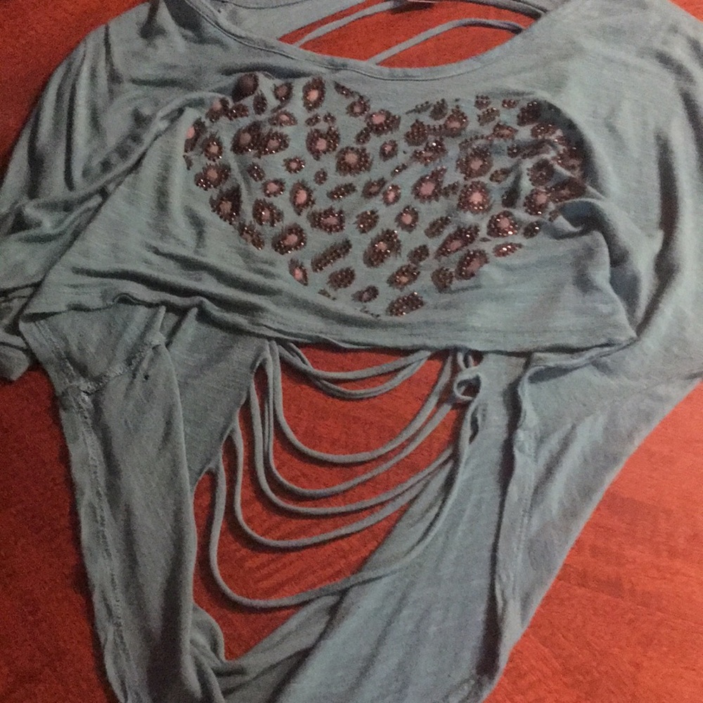 A teal open back shirt with cheetah print